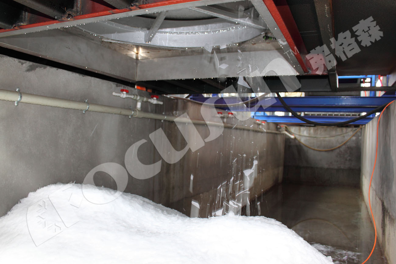 Interior view of a containerized flake ice system showing ice scraping process.